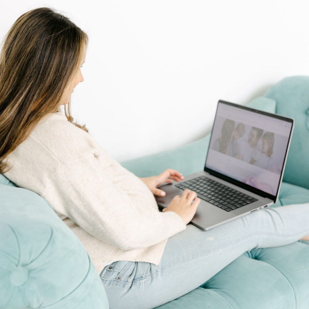 woman on laptop sitting on couch