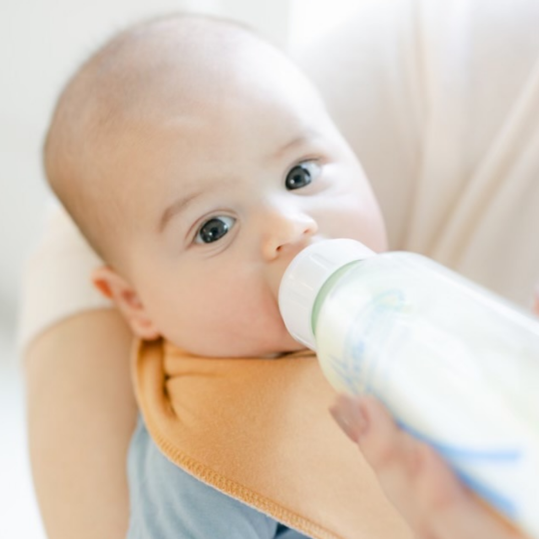 baby sucking on a bottle